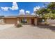 Charming single-story home with a well-manicured gravel yard and a lush tree providing shade and curb appeal at 1750 W Mohawk Ln, Phoenix, AZ 85027