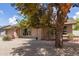 Quaint single-story home with a brick facade, accented by mature trees and easy-care landscaping at 1750 W Mohawk Ln, Phoenix, AZ 85027