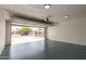 Spacious garage featuring painted concrete floor and automatic door at 1750 W Mohawk Ln, Phoenix, AZ 85027