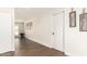 Hallway showcases modern wall decor and dark wood-look flooring at 1750 W Mohawk Ln, Phoenix, AZ 85027