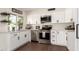 Bright kitchen with white cabinets, stainless appliances, and granite countertops provides a modern and clean cooking space at 1750 W Mohawk Ln, Phoenix, AZ 85027