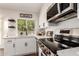 Kitchen showcasing white cabinets, stainless steel appliances, and a bright window at 1750 W Mohawk Ln, Phoenix, AZ 85027
