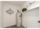 Laundry room featuring painted walls, shelving and a water heater at 1750 W Mohawk Ln, Phoenix, AZ 85027