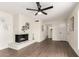 Stylish living room featuring a white brick fireplace and modern ceiling fan at 1750 W Mohawk Ln, Phoenix, AZ 85027