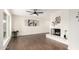 Spacious living room featuring a white brick fireplace and decorative wall art, complemented by sleek wood-look flooring at 1750 W Mohawk Ln, Phoenix, AZ 85027