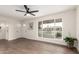 Bright and open living area with a large window, offering great views and ample natural light and modern ceiling fan at 1750 W Mohawk Ln, Phoenix, AZ 85027