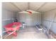 Shed interior containing a red wheelbarrow and gardening supplies at 1750 W Mohawk Ln, Phoenix, AZ 85027