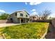 Wide view of the backyard with grass, concrete patio, exterior elevation and block wall at 1761 E 38Th Ave, Apache Junction, AZ 85119
