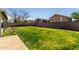 Spacious backyard with lush green grass and a concrete block fence, offering privacy and room to roam at 1761 E 38Th Ave, Apache Junction, AZ 85119