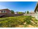 Spacious backyard featuring a large grassy area and block fence for privacy, ideal for outdoor activities at 1761 E 38Th Ave, Apache Junction, AZ 85119