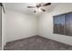 Bedroom offers a ceiling fan, carpeted floors, and natural light from the window at 1761 E 38Th Ave, Apache Junction, AZ 85119