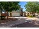 Charming two-story home with lush trees, a driveway, and a two-car garage at 1761 E 38Th Ave, Apache Junction, AZ 85119