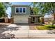 Inviting two-story home featuring stone accents, a two-car garage, and a well-maintained front yard at 1761 E 38Th Ave, Apache Junction, AZ 85119