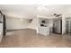 Open layout showcasing a kitchen with gray cabinets and stainless steel appliances adjacent to living space at 1761 E 38Th Ave, Apache Junction, AZ 85119