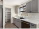 Bright kitchen featuring gray cabinets, a window over the sink and adjacent pantry at 1761 E 38Th Ave, Apache Junction, AZ 85119