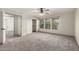 Main bedroom boasts neutral carpet, closet, an ensuite bath, and natural light from windows at 1761 E 38Th Ave, Apache Junction, AZ 85119