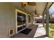 Covered patio features ceiling fans, offering a relaxing outdoor living space with sliding glass doors at 1761 E 38Th Ave, Apache Junction, AZ 85119