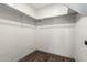 Walk-in closet features wood floors and closet rods for optimal organization at 1761 E 38Th Ave, Apache Junction, AZ 85119