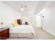 Bright bedroom featuring neutral carpet, white walls, ceiling fan and closet at 17627 N 104Th Ave, Sun City, AZ 85373