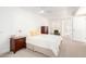 Bright bedroom with neutral carpet, white walls, ceiling fan and walk-in closet at 17627 N 104Th Ave, Sun City, AZ 85373