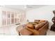 Bright and airy living room showcasing a leather sofa and access to the outdoor patio at 17627 N 104Th Ave, Sun City, AZ 85373
