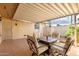 Covered patio area with tiled floor, seating, and decorative string lights at 17627 N 104Th Ave, Sun City, AZ 85373