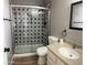 Well-lit bathroom with unique patterned shower and a vanity with a sink and ample counter space at 1876 N Parkside Ln, Casa Grande, AZ 85122