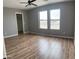 Spacious bedroom with wood-look floors, a ceiling fan and natural light from two windows at 1876 N Parkside Ln, Casa Grande, AZ 85122