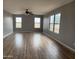 Bright, airy bedroom with wood floors and large windows at 1876 N Parkside Ln, Casa Grande, AZ 85122
