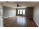 Bedroom featuring a ceiling fan, wood floors, and bright windows at 1876 N Parkside Ln, Casa Grande, AZ 85122