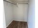 Walk-in closet with wood-look floors and shelving, offering ample space for storage at 1876 N Parkside Ln, Casa Grande, AZ 85122