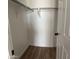 Clean closet with white walls and wood-look flooring, offering ample space for storage at 1876 N Parkside Ln, Casa Grande, AZ 85122