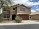 Two-story home with neutral paint, red tile roof, and two-car garage at 1876 N Parkside Ln, Casa Grande, AZ 85122