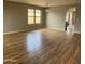 Spacious living room boasts wood-look flooring and lots of natural light at 1876 N Parkside Ln, Casa Grande, AZ 85122