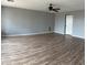 Living room with ceiling fan, wood-look floors, and new paint at 1876 N Parkside Ln, Casa Grande, AZ 85122