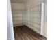 Spacious pantry with ample shelving and modern wood flooring at 1876 N Parkside Ln, Casa Grande, AZ 85122