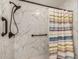 Bathroom features a shower with marble-look walls, grab bars, and a shower curtain at 19645 N 3Rd Ave, Phoenix, AZ 85027