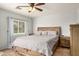 Comfortable bedroom with ceiling fan, wood-look floors, and an inviting neutral color palette at 19645 N 3Rd Ave, Phoenix, AZ 85027