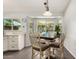 Eat-in kitchen with large windows overlooks the pool with white cabinetry and stainless steel dishwasher at 19645 N 3Rd Ave, Phoenix, AZ 85027