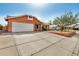Single-story home with a two-car garage, complemented by mature landscaping and a spacious driveway at 19645 N 3Rd Ave, Phoenix, AZ 85027