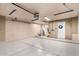 Spacious garage features an epoxy floor, ample lighting, and convenient access door with a BMW logo at 19645 N 3Rd Ave, Phoenix, AZ 85027