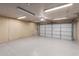 Spacious garage with updated epoxy flooring, pegboard, and overhead lighting ready for parking and projects at 19645 N 3Rd Ave, Phoenix, AZ 85027