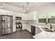 Bright kitchen features stainless steel appliances, white cabinets, and marble countertops at 19645 N 3Rd Ave, Phoenix, AZ 85027
