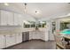 Bright kitchen featuring white cabinets, marble countertops, stainless steel appliances, and a dining nook at 19645 N 3Rd Ave, Phoenix, AZ 85027