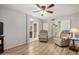 Open-concept living area with neutral walls, two recliners, and connecting doorways at 19645 N 3Rd Ave, Phoenix, AZ 85027