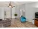 Spacious living room with laminate floors, offering a view of the front door and a bright blue accent chair at 19645 N 3Rd Ave, Phoenix, AZ 85027