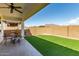 Covered patio and low-maintenance artificial turf backyard at 21056 W Granada Rd, Buckeye, AZ 85396
