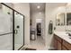 Bathroom featuring glass shower, vanity sink, and access to walk-in closet at 21056 W Granada Rd, Buckeye, AZ 85396