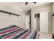 Bedroom features a bed, ceiling fan, closet and access to the ensuite at 21056 W Granada Rd, Buckeye, AZ 85396