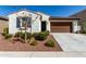 Charming home featuring a low-maintenance landscaped front yard and attached two-car garage at 21056 W Granada Rd, Buckeye, AZ 85396